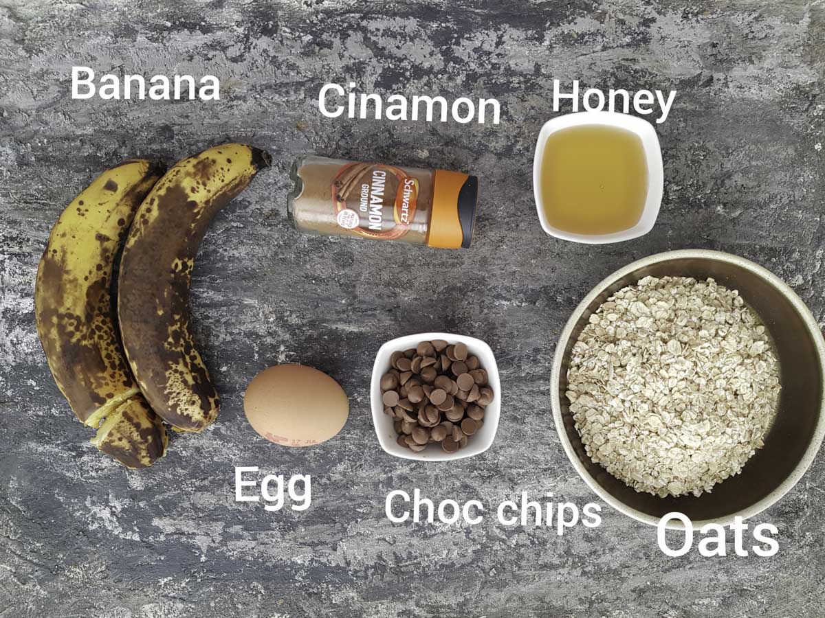 ingredients photo showing bananas, oats, honey, egg, chocolate chips, cinnamon