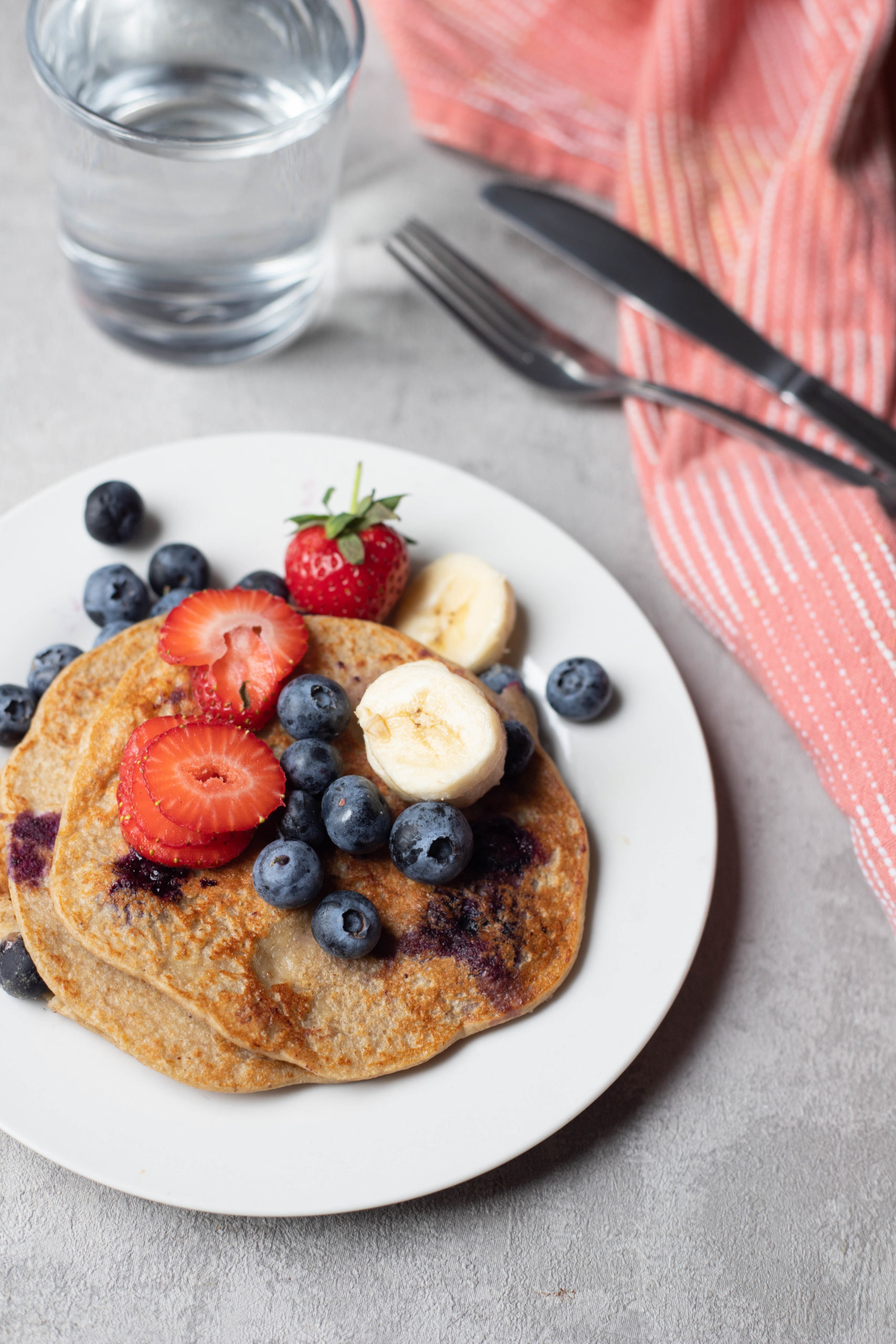 banana pancakes served with fruit