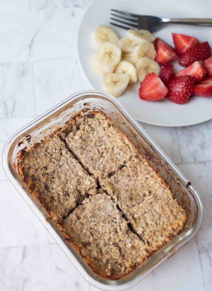 Baked oatmeal in a pyrex dish with fruit on the side