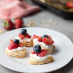 strawberry-puff-pastry-bites with cream strawberries and blueberries