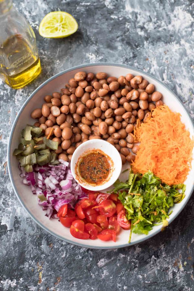 beans,grated carrot,chopped onion, tomatoes, cilantro, a small bowl of dressing