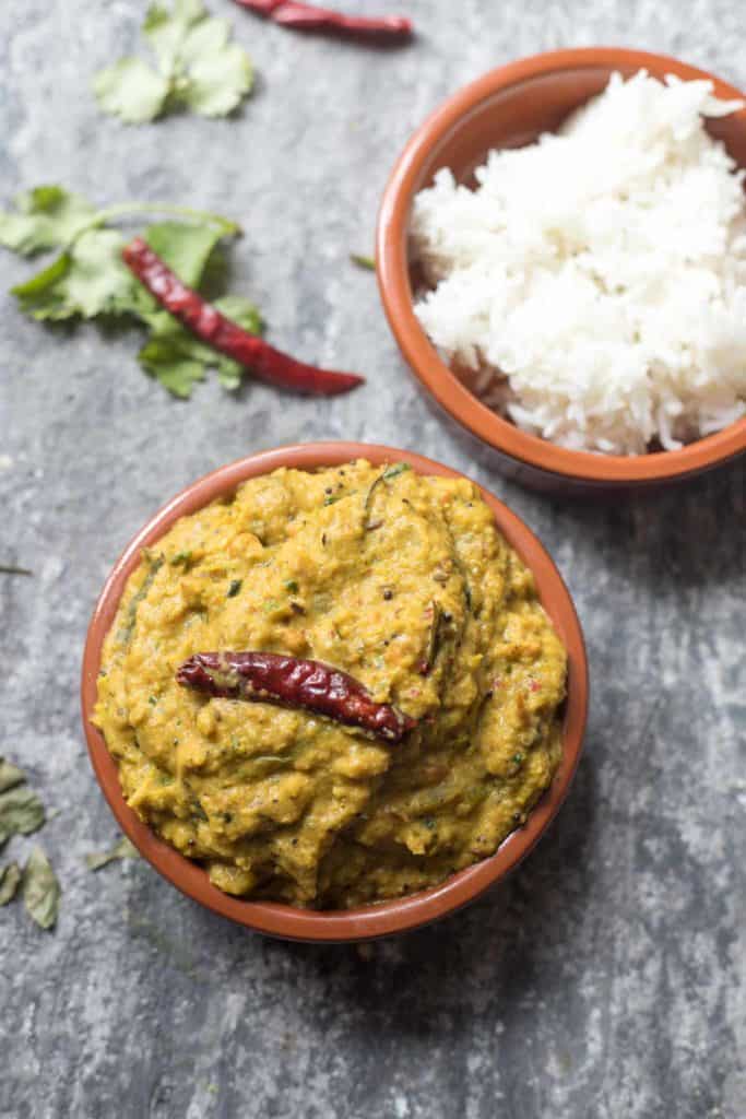 a bowl of green tomato chutney and a bowl of white rice