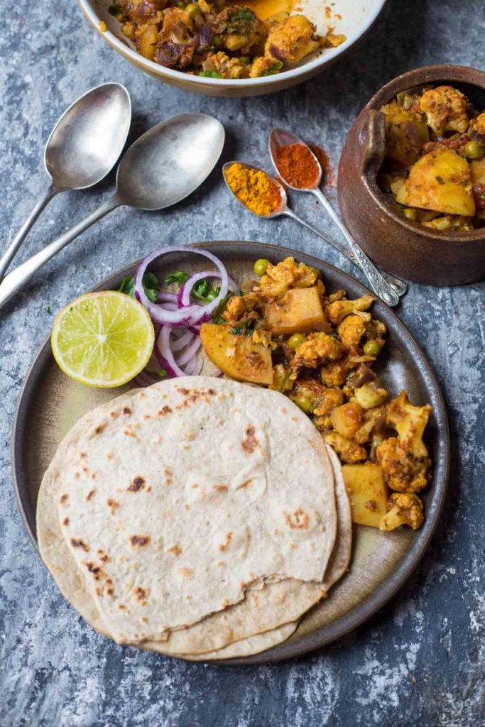 3 rotis, aloo gobi curry, onion slices, lemon wedge