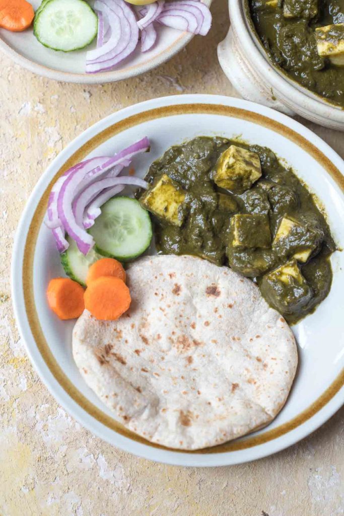 healthy palak paneer , chapati salad on a plate