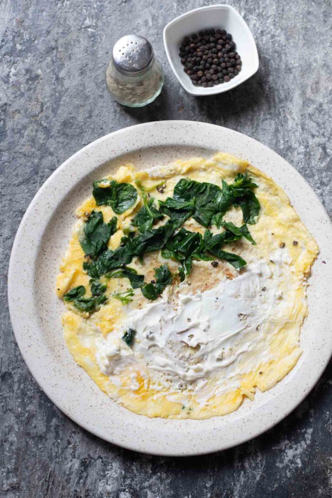 high protein cottage cheese omelette served on a white plate