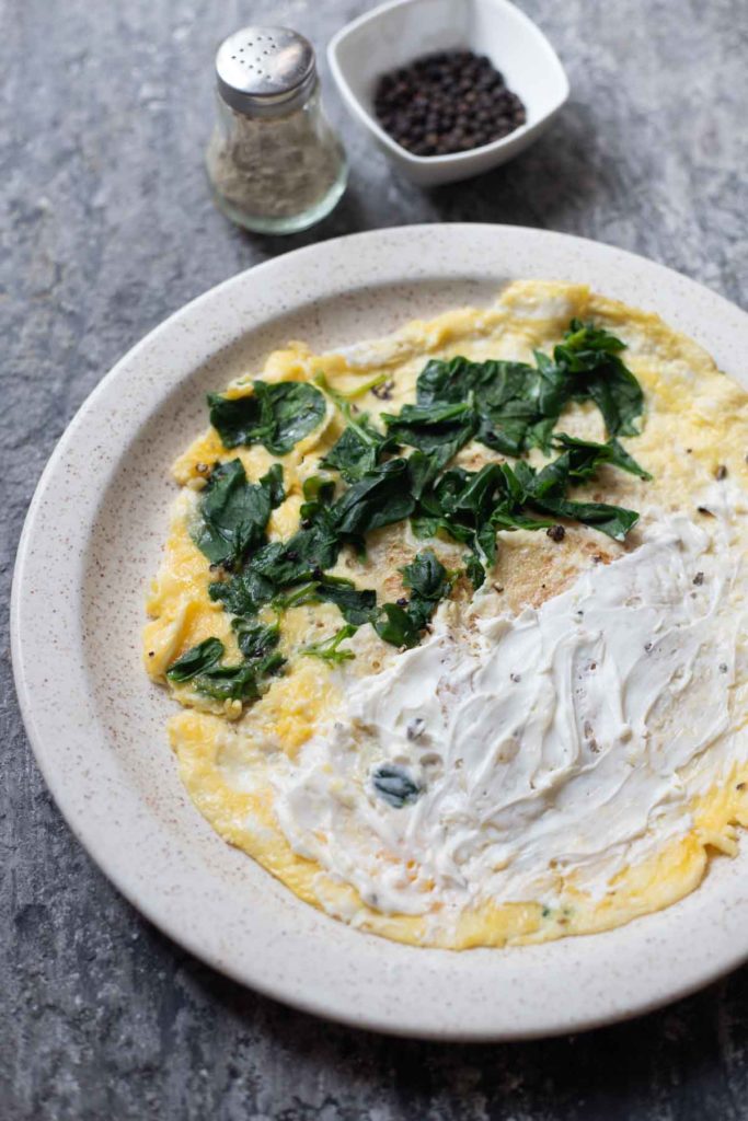 high protein cottage cheese omelette served on a white plate