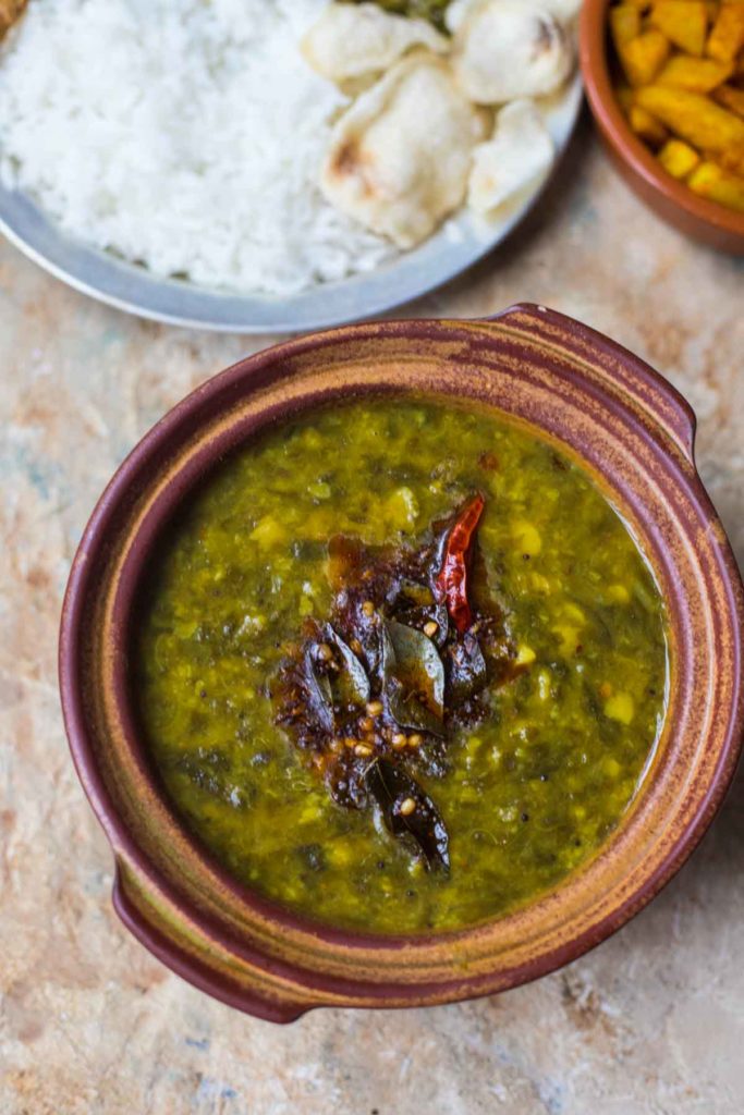 andhra gongura pappu served in an earthern pot with rice