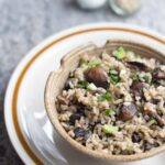 a bowl of mushroom fried rice with chopsticks