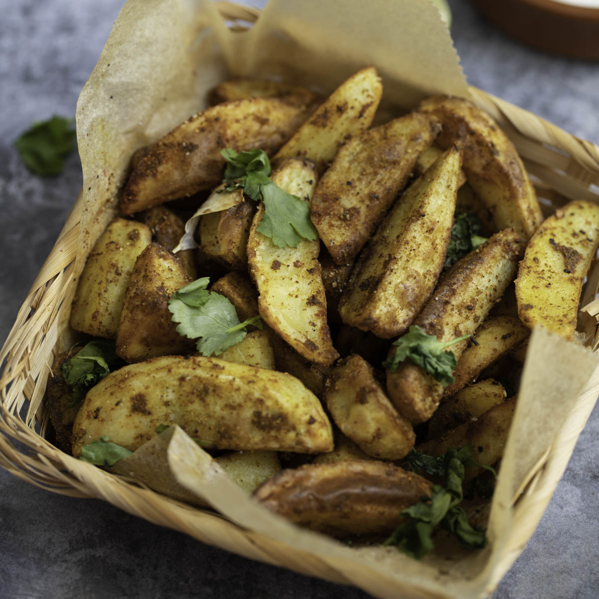 moroccan spiced potato wedges in a baking pape 