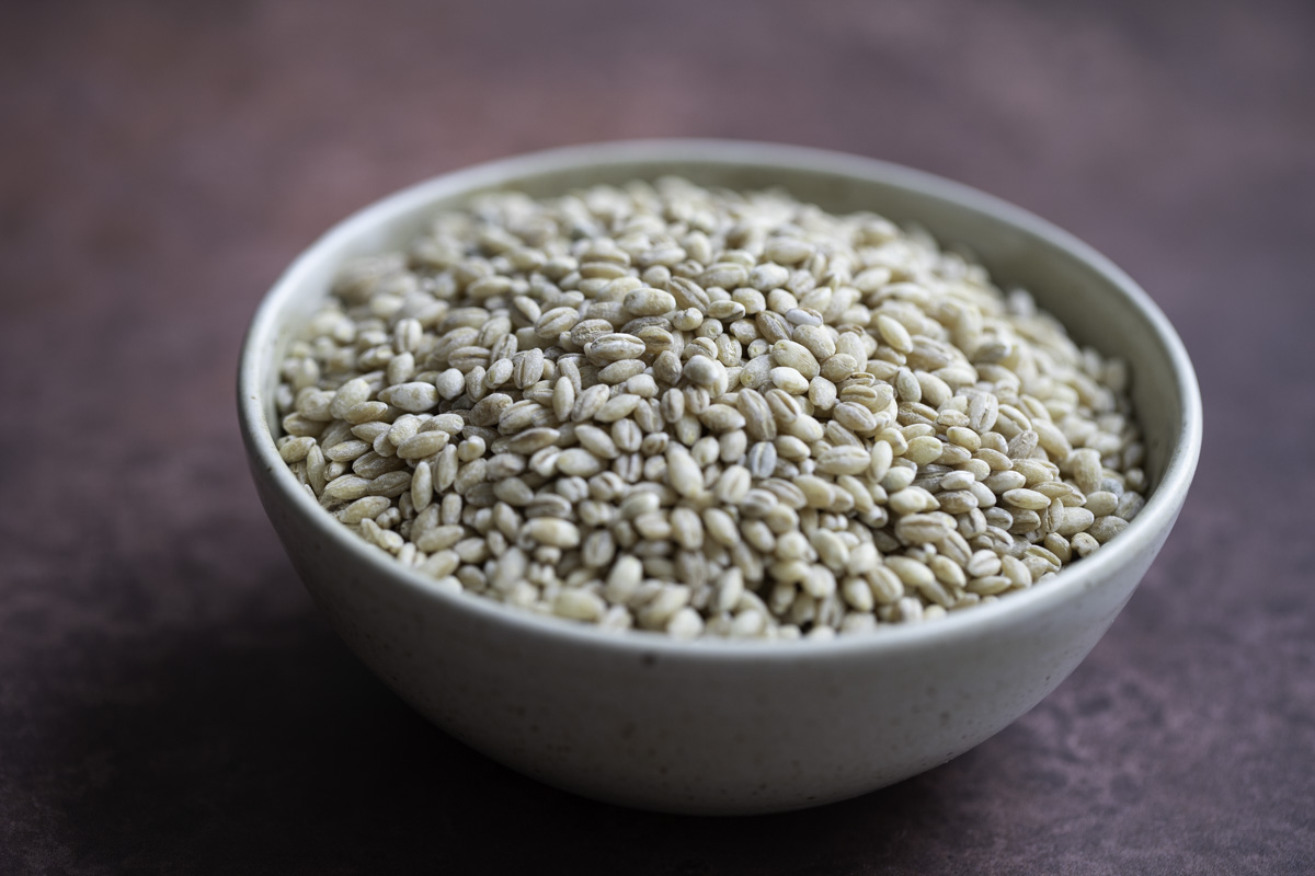 a bowl of uncooked pearl barley grains