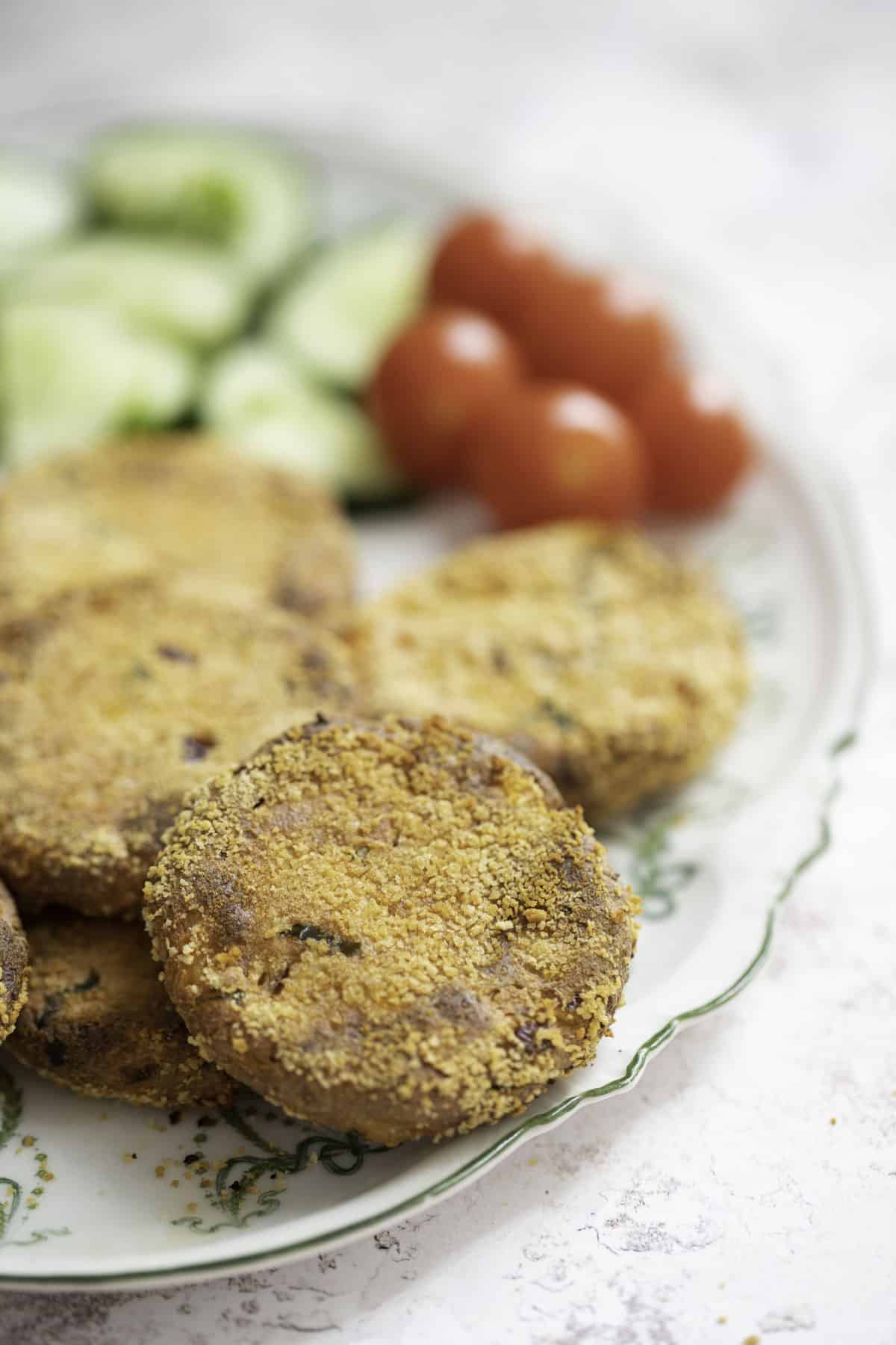 crispy baked paneer cutlets served with cucumber and tomato salad