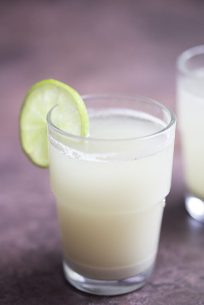 rice bran juice serve in a glass with lemon wedge